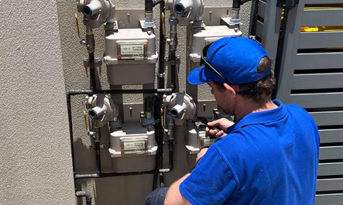 Plumber turning off gas at mains