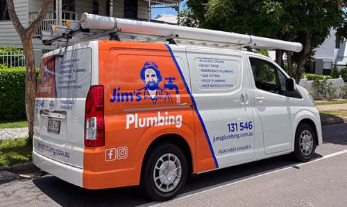 Jim's Plumbing van outside residential house on street